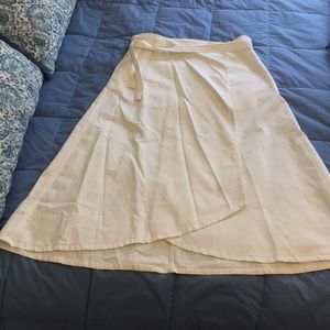 white wrap around below knee skirt with pockets.